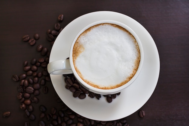 Hot coffee in a white cup on the table.