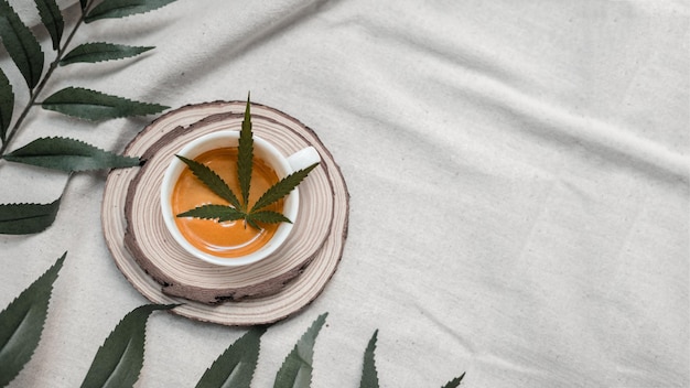 hot coffee with cannabis leaf on the table