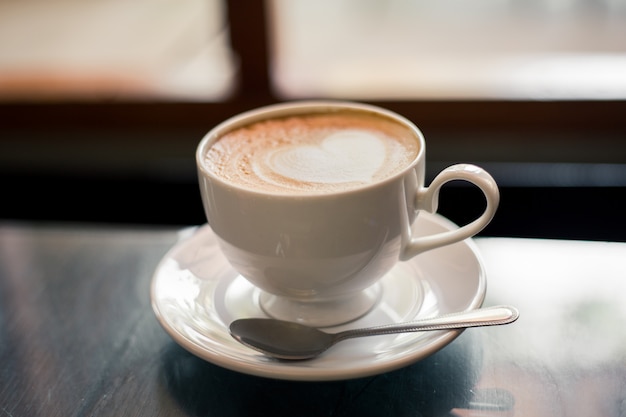 Hot coffee on a wooden table in a coffee shop