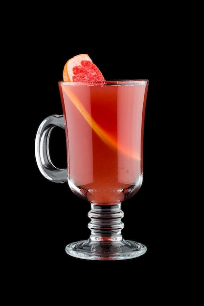 Hot cranberry drink with grapefruit Sbiten Russian traditional cuisine On dark backgroundWarming drink