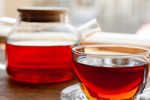 Hot cup of tea on wooden rustic table close up