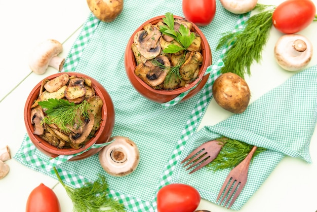 Hot and delicious dish of mushrooms, meat and potatoes baked in the oven. Top view.