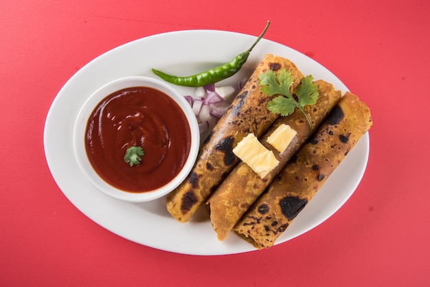 Hot delicious paratha with ghee and tomato sauce