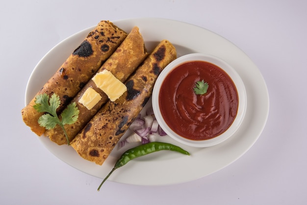 Hot delicious paratha with ghee and tomato sauce