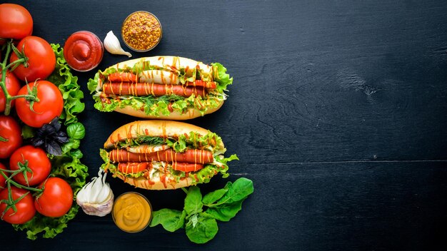 Hot dog with grilled sausage mustard and ketchup onions and greens on Wooden background Top view Free space