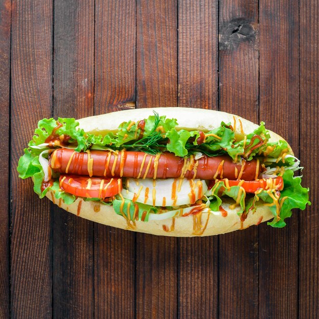 Hot dog with herbs and spices mustard and ketchup On Wooden background Top viewing space