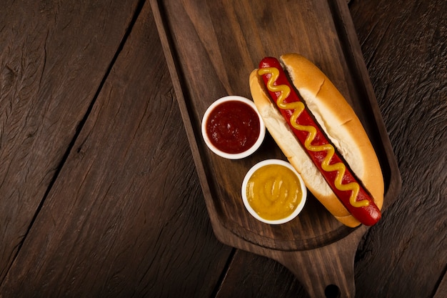 Hot dog with ketchup and yellow mustard