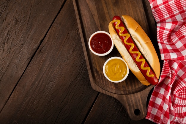 Hot dog with ketchup and yellow mustard