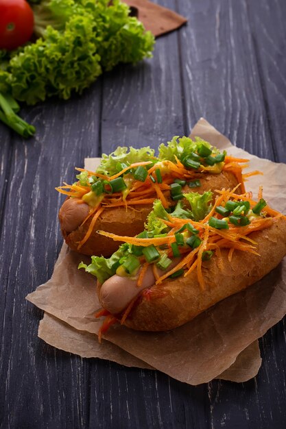 Hot dog with sausage, carrot, onion, lettuce 