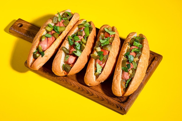 Hot dog on a yellow background, hot dog with sausage.