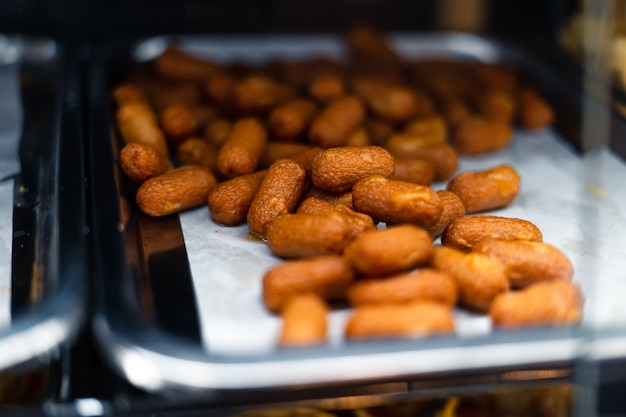 Hot dogs fried in a tray at a Buffet restaurant