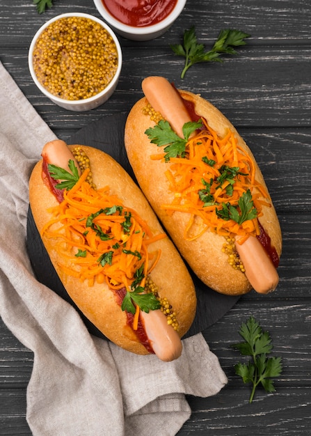 Hot dogs with carrots flat lay