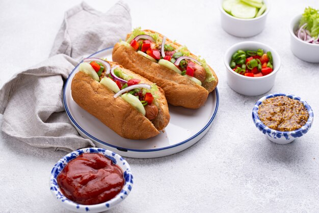 Hot dogs with sausage, sauces and vegetables