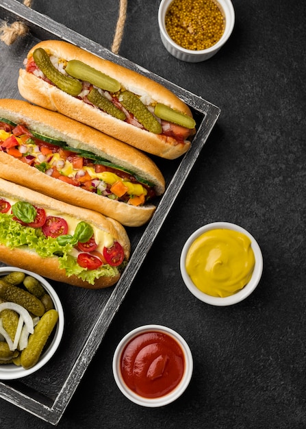 Hot dogs with vegetables flat lay