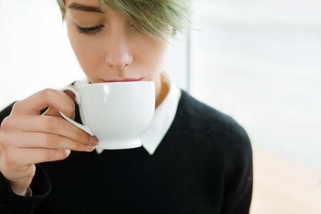 Hot drink girl tasting coffee tea cup beverage