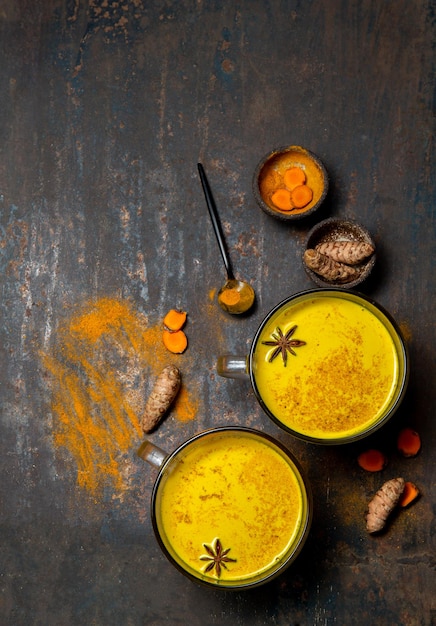 Hot drink golden milk turmeric latte with curcuma powder and spices. Top view.