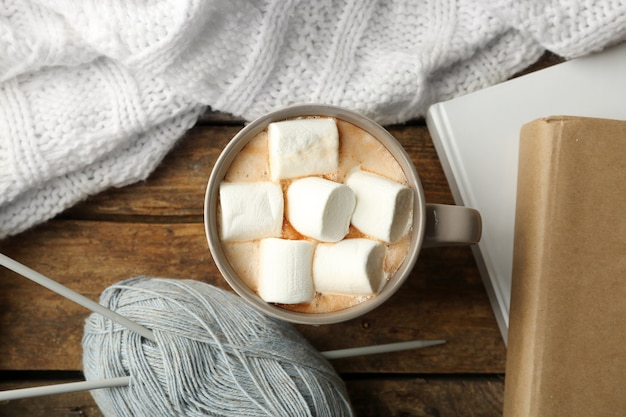 Hot drink with marshmallows on table, top view