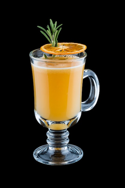 A hot drink with orange almonds and spices On dark background Warming drink