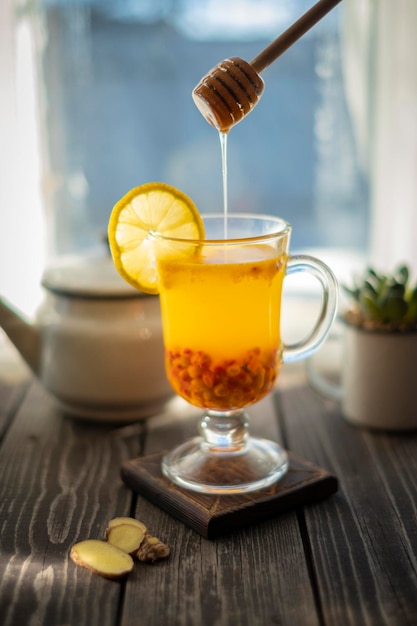 Hot drink with sea buckthorn berry ginger lemon and honey