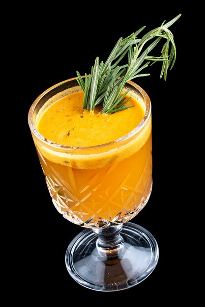 Hot drink with sea buckthorn and rosemary On dark background