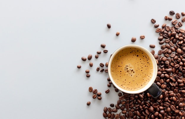 Hot espresso and coffee bean on table 