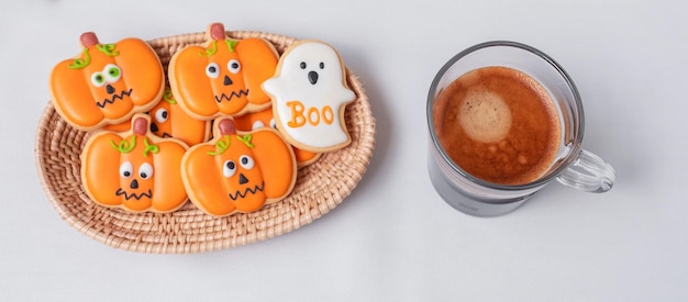 Hot espresso coffee or chocolate cup with funny Halloween Cookies Happy Halloween day Trick or Threat Hello October fall autumn Traditional party and holiday concept