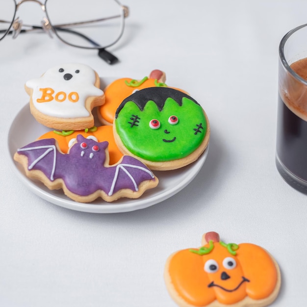 Hot espresso coffee or chocolate cup with funny Halloween Cookies Happy Halloween day Trick or Threat Hello October fall autumn Traditional party and holiday concept