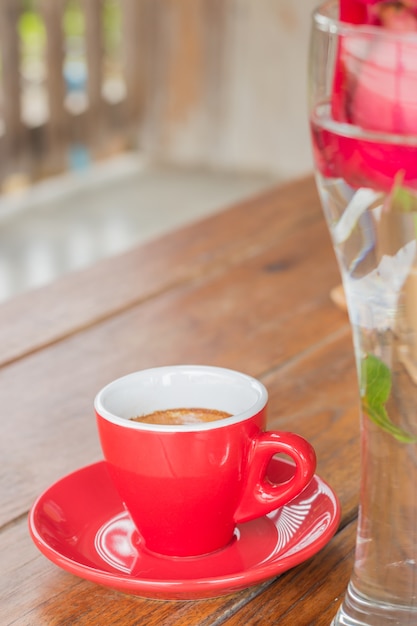 Hot espresso serving on wooden table