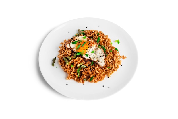 Hot fresh noodles with fried egg isolated on a white background. High quality photo