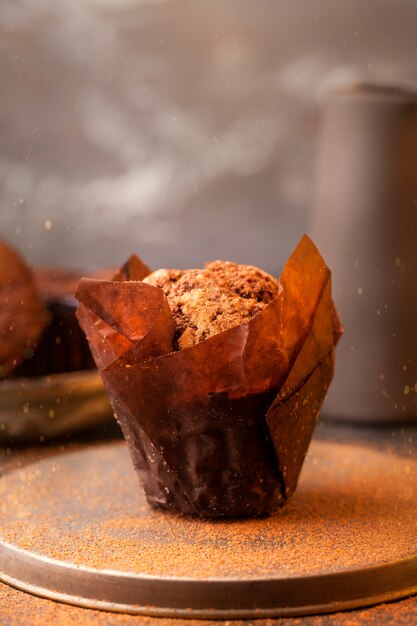 Hot freshly baked brownie with chocolate pieces in craft paper with cinnamon