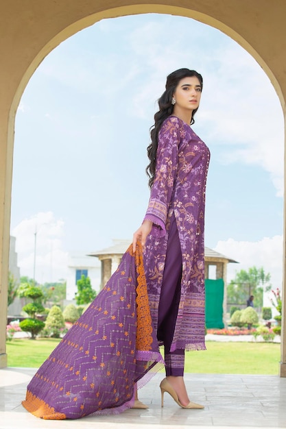 Hot Girl Side Pose for Fashion Shoot in Garden Wearing Purple Traditional Dress and Holding Dupatta