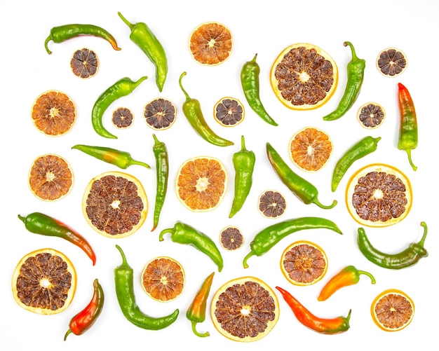 Hot green peppers and dried citrus fruit on a white background grocery organic flatley