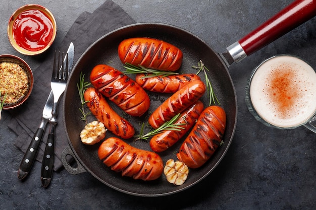 Hot grilled sausages in a frying pan