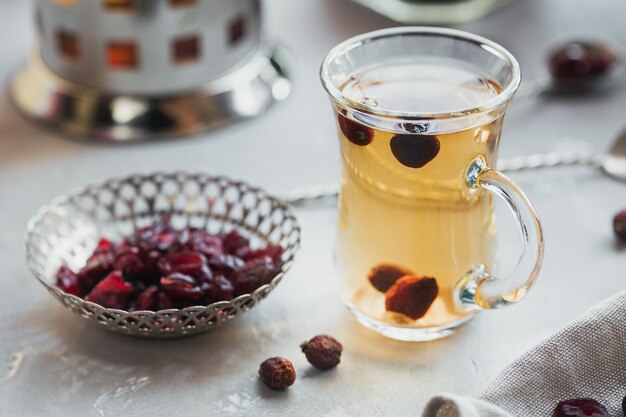 Горячий травяной чай с шиповником в стеклянной чашке. Концепция здорового питания.