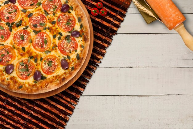 나무 테이블에 모짜렐라와 토마토와 함께 뜨거운 수제 이탈리아 피자 마르게리타