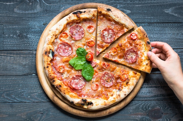 Hot Italian pizza on a rustic wooden table.