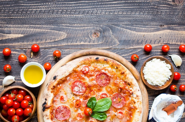 Hot Italian pizza on a rustic wooden table.