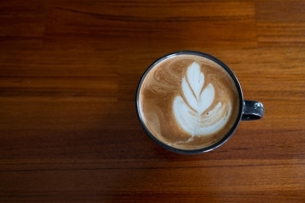 Hot latte art coffee on wood table relax timexA