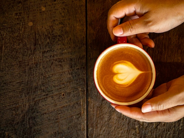 Hot latte art on wood table