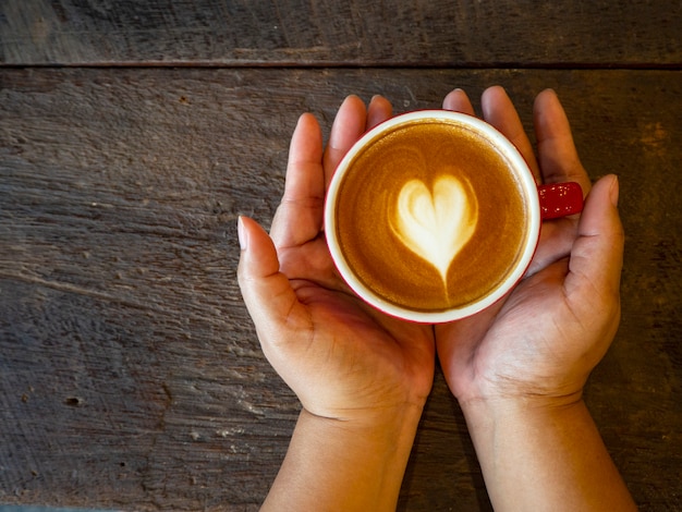 Hot latte art on wood table