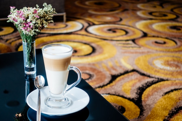 Hot latte coffee cup on table