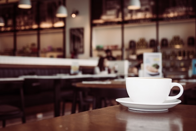 Hot latte coffee in white cup on table in restaurant and cafe