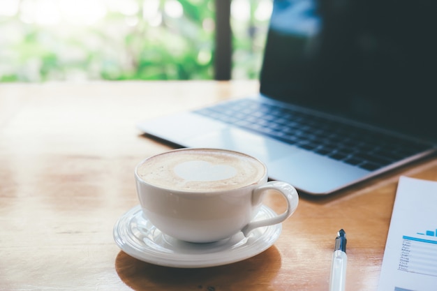 Hot latte coffee on working table. 