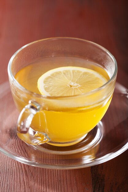 Hot lemon ginger tea in glass cup