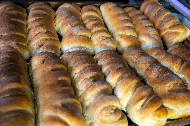 Hot loaves are laid out in trays for sale