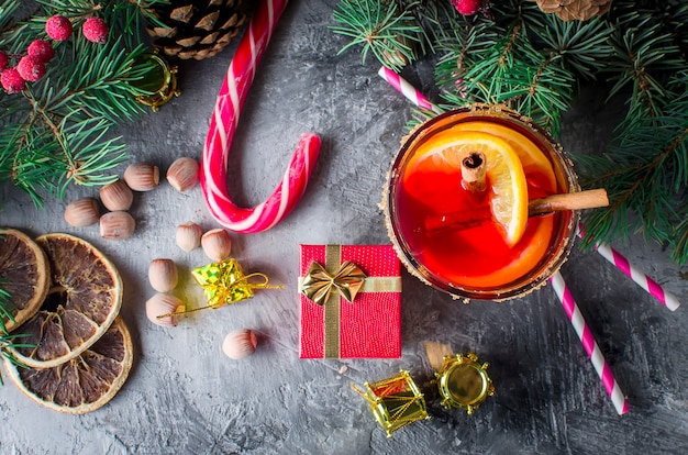 Hot mulled wine drink with orange, and christmas decorations