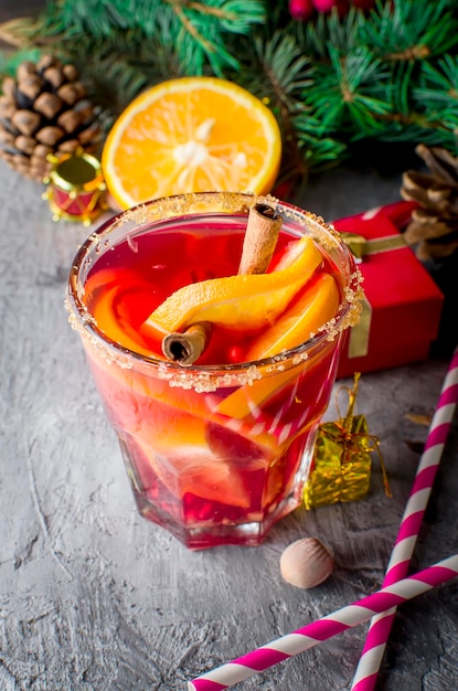 Hot mulled wine drink with orange and christmas decorations