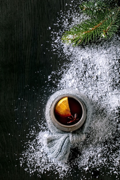 Hot mulled wine with spices and Christmas decorations