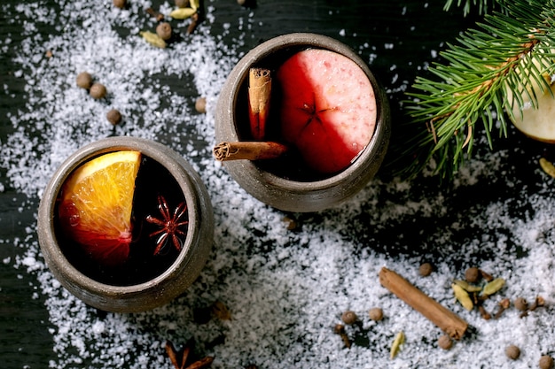 Hot mulled wine with spices and Christmas decorations