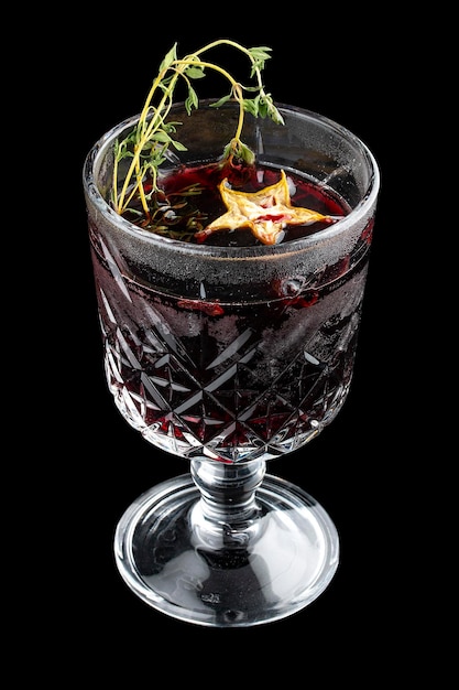 Hot mulled wine with thyme On dark background